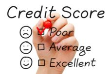 23097403 - hand putting check mark with red marker on poor credit score evaluation form.