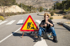 57675152 - lazy guy on a road works site, a concept