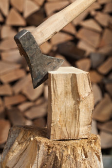 65623649 - chopping firewood detail with wooden block and axe