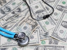 26883545 - stethoscope on pile of american dollar banknotes
