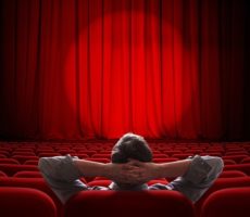 27838925 - man sitting alone in empty theater or cinema hall